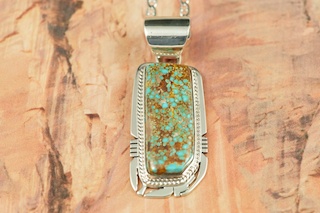 Genuine Number 8 Mine Turquoise Stone set in Sterling Silver Pendant. Free 18" Sterling Silver Chain with Purchase of Pendant. Created by Navajo Artist Phillip Sanchez. Signed by the artist. The Number 8 mine is located in Eureka County Nevada. Since 1976 there has been no Number 8 Turquoise mined. There is however, an existing stock pile that Mr. Dowell Ward, the last owner of the Number 8 mine, had stocked away for later sorting. The Turquoise is a collector's item--because once the reserve is gone there will be no more material released onto the market. The Gold Mining Company owns the claim to the Number 8 mine and it has been swallowed up by the gold mining operations. This is some of the last Number 8 Turquoise to be had and will be a great addition to your collection. 